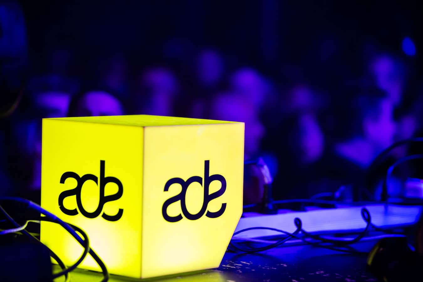 A lighting installation cube with the Amsterdam Dance Event (ADE) logo on it.