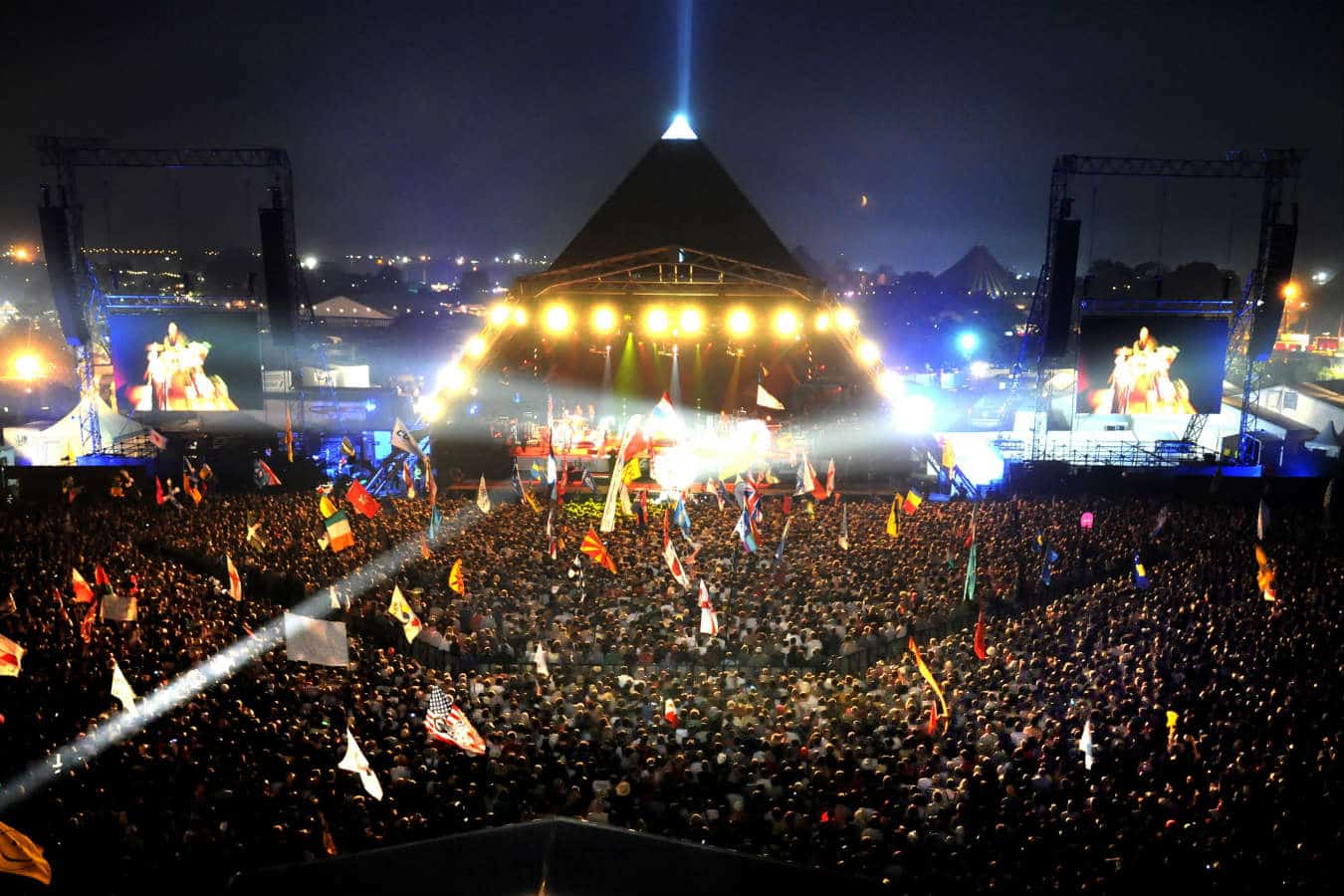 A photo of a crowd in front of the main stage at Glastonbury Festival 2013.