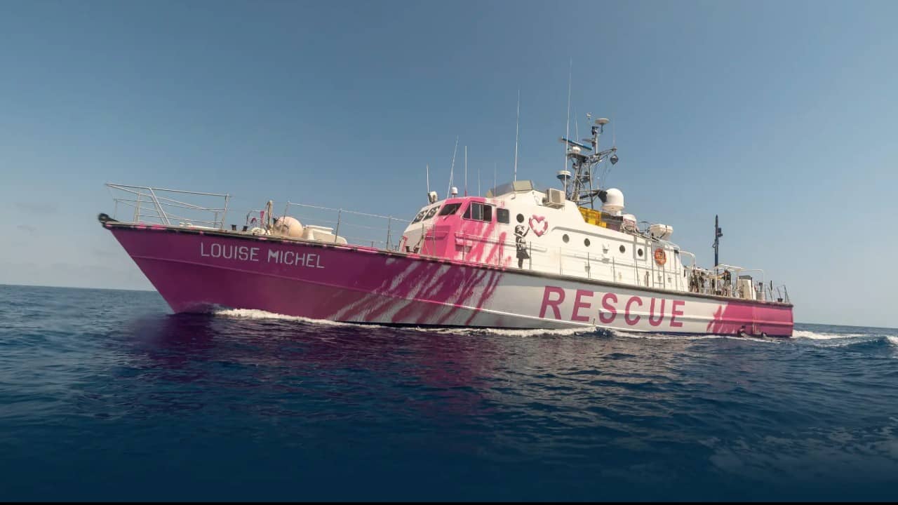 A photo of Banksy and Pia Klemp's refugee boat, the Louise Michel.