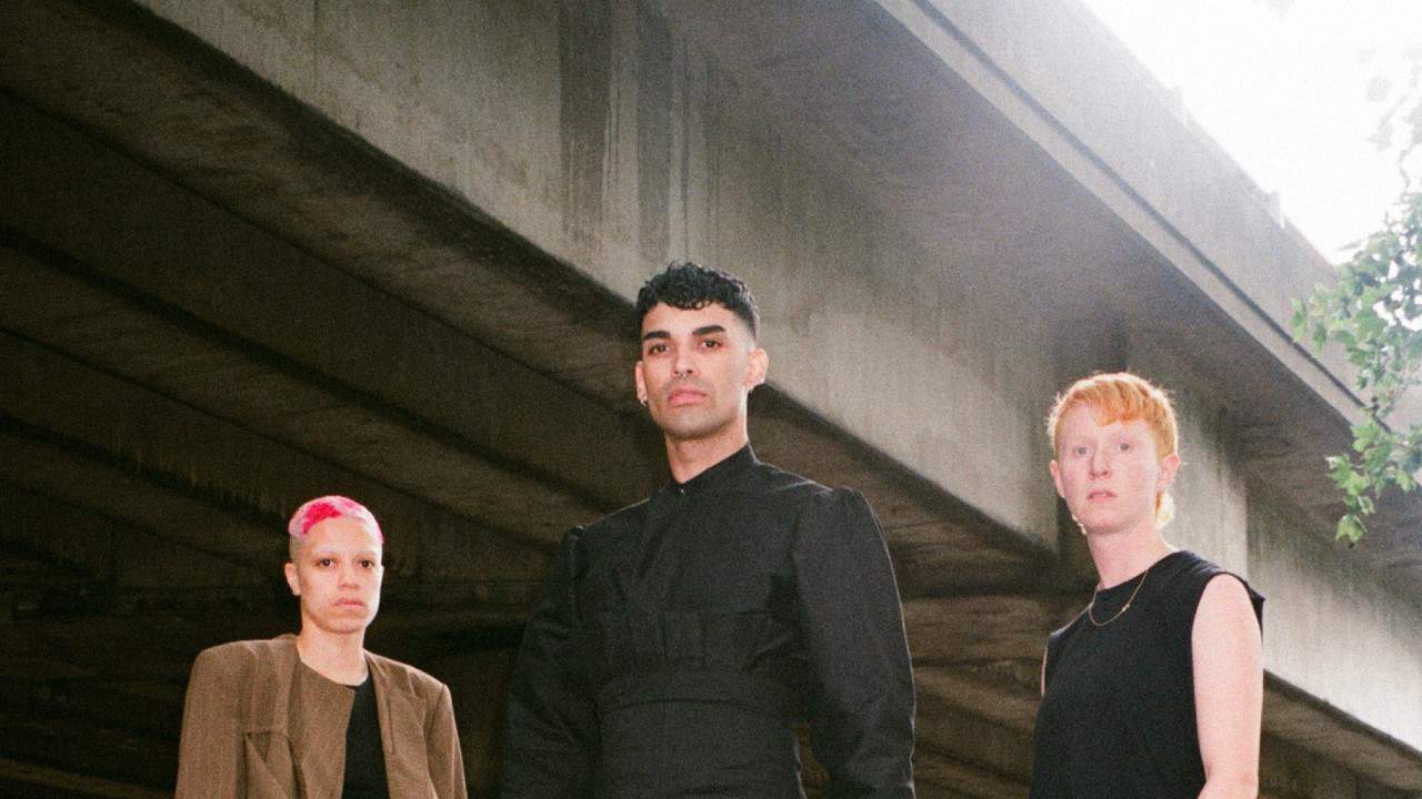 A photo of Wax Wings and NIMMO standing under a bridge by Roxy Lee.